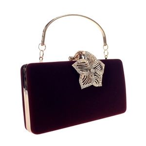 Détail de la pochette de soirée en velours bordeaux avec fermoir fleur orné de cristaux