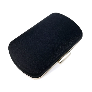 Close-up of black glitter evening clutch with gold metal frame and top push-lock
