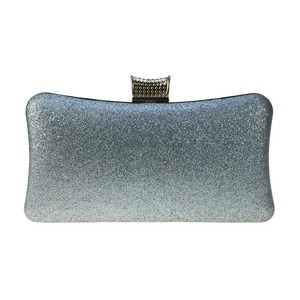 Close-up of sparkling silver-blue glitter fabric on an elegant evening clutch bag