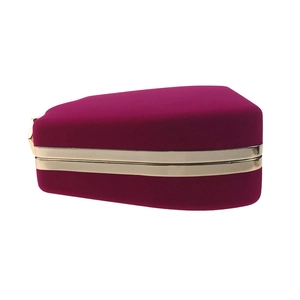 Detailed side view of fuchsia velvet jewelry clutch box with polished gold metal frame