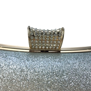 Elegant silver glitter evening clutch bag with sparkling rhinestone encrusted arched frame