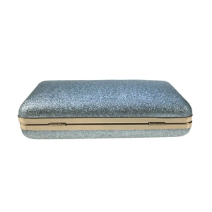 Detail view of the side structure and gold metal hinge on this blue glitter evening clutch