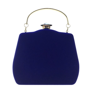 Detail of royal blue velvet evening bag with gold metal handle and crystal clasp