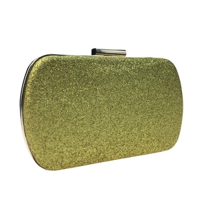 Detail of evening clutch bag featuring golden sequins and a metallic push-lock closure