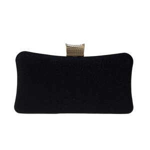 Detailed view of the black glitter evening bag with textured pale gold metal clasp