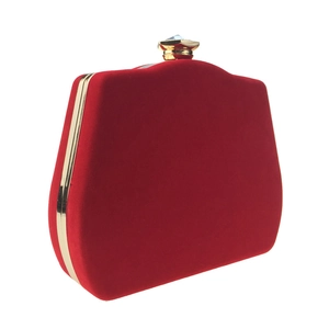 Detail view of red velvet evening clutch featuring gold frame and crystal buckle lock