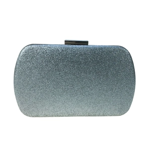 Detailed view of silver glitter sequins on a rectangular hard shell evening clutch bag