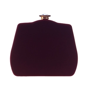 Close-up of wine red velvet evening bag featuring a gold-toned rhinestone crystal clasp