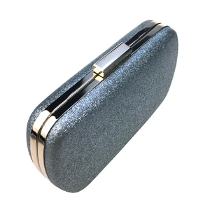 Detail view of the metallic frame and glitter surface on this silver hard shell clutch bag