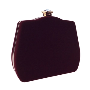 Macro view of burgundy velvet evening bag with gold metal frame and crystal clasp detail