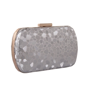 Detailed close-up of a silver clutch with pebble texture and rose gold metal frame