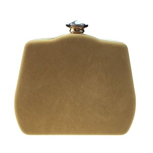 Detailed view of the sparkling crystal clasp and gold velvet texture of the clutch bag