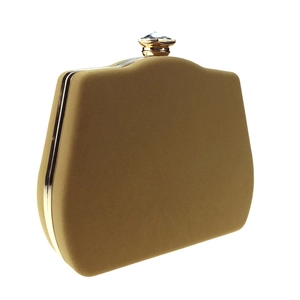 Detail of champagne velvet evening clutch with gold metal frame and jewel-encrusted clasp