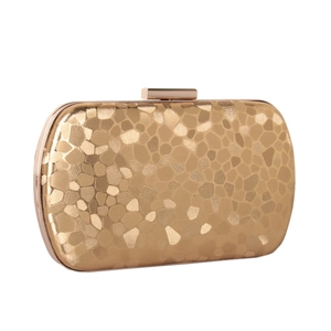 Detail of champagne gold evening clutch with geometric pattern and metal frame
