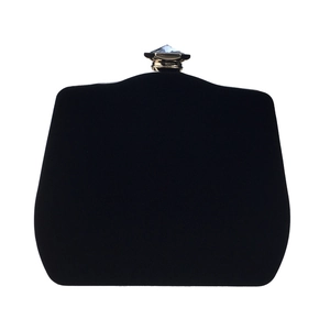 Detail of black velvet evening bag with gold trim and transparent gemstone clasp