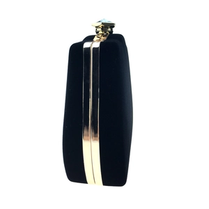 Detailed side view of black velvet evening bag with a crystal-embossed gold metal clasp