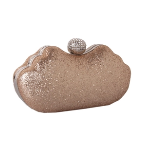 Detail of champagne gold sequin evening clutch with crystal-encrusted ball clasp closure