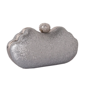 Detail of silver sequin evening clutch bag with sparkling finish and diamond spherical clasp