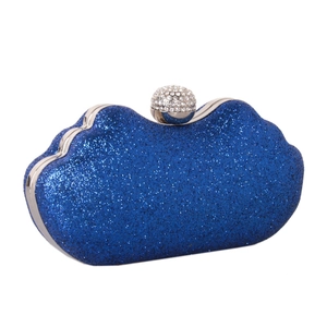 Close-up of royal blue sequin clutch evening bag with silver diamond encrusted ball clasp