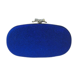 Close-up of blue glitter oval evening clutch featuring a rhinestone bow metal clasp