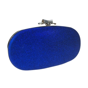 Detail of royal blue glitter evening bag featuring a rhinestone bow clasp on top