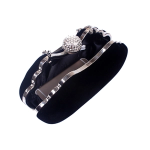 Detail showing black velvet interior and rhinestone clasp holding a smartphone