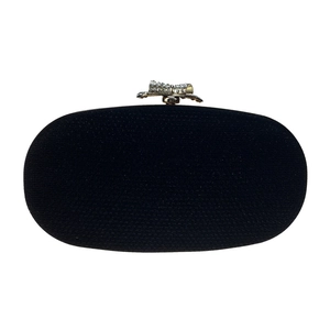 Detail of silver bow clasp with sparkling rhinestones on black oval evening clutch bag