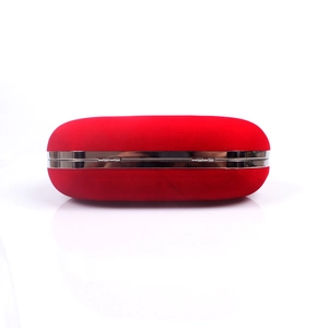 Detailed view of luxury red velvet evening clutch bag with silver metal frame closure
