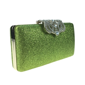 Detail of glittery green evening clutch bag with sparkling rhinestone closure detail