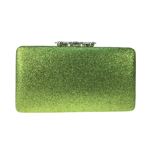 Detailed close-up of sparkling green glitter evening clutch with silver metal clasp