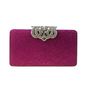 Detailed view of rose red sequin evening clutch featuring ornate silver rhinestone clasp