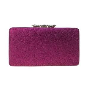 Macro detail of rose red sequin evening bag featuring pearl and rhinestone metal clasp