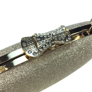 Champagne gold sequin evening clutch with a sparkling rhinestone bow closure