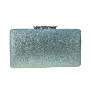 Close-up of the elegant silver-blue sequins and gold metal clasp on the luxury clutch bag