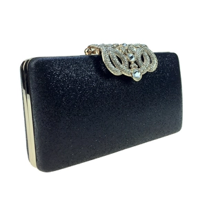 Macro shot of black sequin clutch bag with baroque rhinestone clasp and gold frame