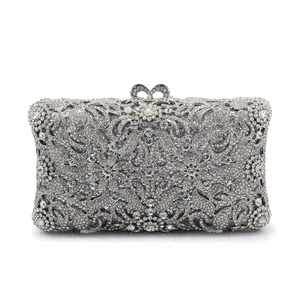 Silver rhinestone evening clutch with hollow floral crystal patterns and bow clasp