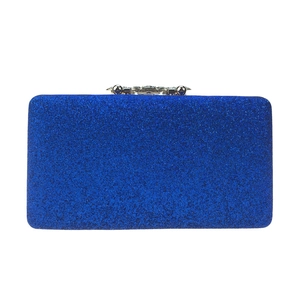 Macro shot of blue sequin evening clutch with rhinestone buckle and shimmering texture