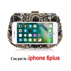 Internal view of handmade beaded evening clutch bag holding an iPhone 6 Plus for scale