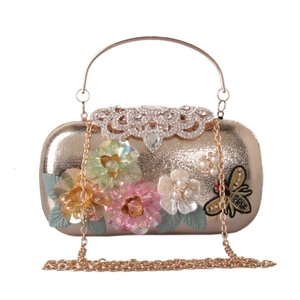 Detail of evening clutch with 3D floral sequins, beaded bee and rhinestone clasp