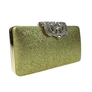 Detail of gold evening clutch with sequin texture and rhinestone encrusted ring clasp