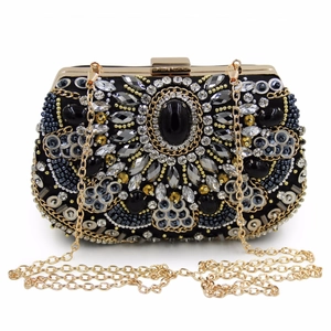 Macro detail of hand-beaded embroidery with crystal rhinestones and central black gemstone
