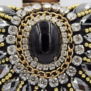 Macro view of hand-beaded vintage evening bag with black gemstone and crystal embroidery