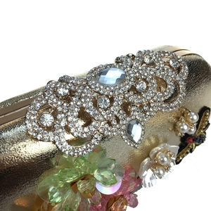 Detailed macro view of luxury evening bag with sequins, pearls and 3D floral embellishments