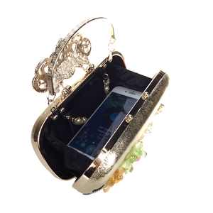 Top view showing black fabric interior and capacity of gold floral evening bag