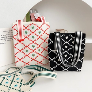 Three multi-colored knitted tote bags with geometric patterns and striped handles