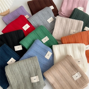 Classic ribbed knit scarf in multiple solid colors with minimalist emo woven label