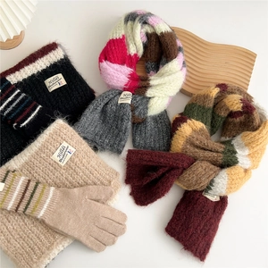 Winter knit accessory set featuring striped multi-color scarves and warm beige gloves