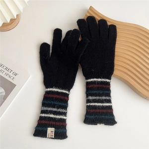 Detail of black knit gloves with colorful striped cuffs and HI Made fabric label