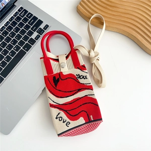 Detail of knitted mini crossbody bag with red wave pattern and love you letters