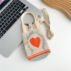 Detailed knit texture of mini heart shoulder bag with metal snap and ivory handle